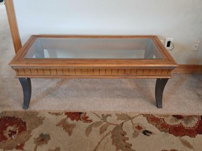Elegant Glass-Top Coffee Table with Carved Wood Trim
