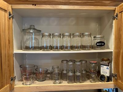 CANNING JARS, MEASURING CUPS AND AN APOTHECARY JAR