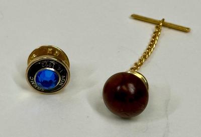 Sale Photo Thumbnail #122: Reddish-brown solid wood tie tac and gold-tone 45 Year Service Anniversary Lapel Pin (faux sapphire) from the San Gabriel Valley Medical Center. Both in good condition.