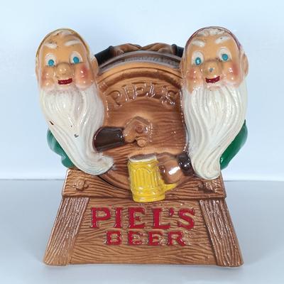 LOT 242: Vintage Piel's Beer Cast Metal Gnome-Themed Bottle Holder
