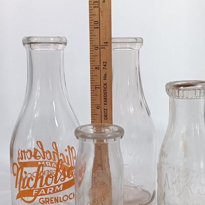 LOT 88: Set of (7) Vintage Milk Bottles