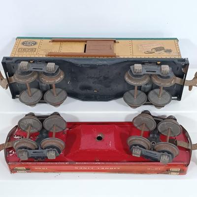 LOT 193: Lionel 1682 Red Caboose, 1680 Sunoco Tank Car, Flat Car with Lumber, 1679 Baby Ruth Box Car & More