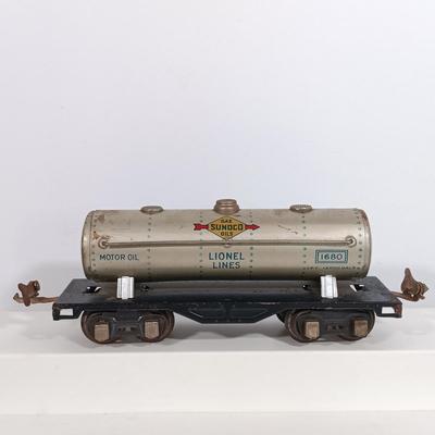 LOT 193: Lionel 1682 Red Caboose, 1680 Sunoco Tank Car, Flat Car with Lumber, 1679 Baby Ruth Box Car & More
