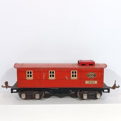LOT 193: Lionel 1682 Red Caboose, 1680 Sunoco Tank Car, Flat Car with Lumber, 1679 Baby Ruth Box Car & More