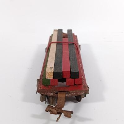 LOT 193: Lionel 1682 Red Caboose, 1680 Sunoco Tank Car, Flat Car with Lumber, 1679 Baby Ruth Box Car & More