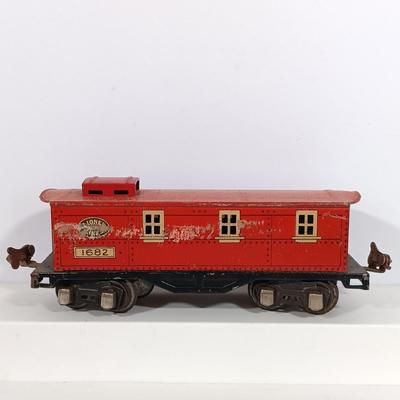 LOT 193: Lionel 1682 Red Caboose, 1680 Sunoco Tank Car, Flat Car with Lumber, 1679 Baby Ruth Box Car & More