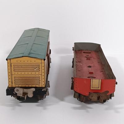 LOT 193: Lionel 1682 Red Caboose, 1680 Sunoco Tank Car, Flat Car with Lumber, 1679 Baby Ruth Box Car & More