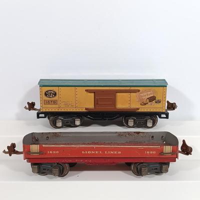 LOT 193: Lionel 1682 Red Caboose, 1680 Sunoco Tank Car, Flat Car with Lumber, 1679 Baby Ruth Box Car & More