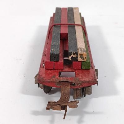 LOT 193: Lionel 1682 Red Caboose, 1680 Sunoco Tank Car, Flat Car with Lumber, 1679 Baby Ruth Box Car & More