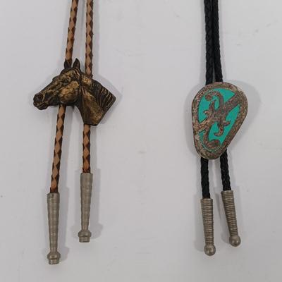 LOT 195: Tony Lama Tooled Leather Acorn Belt, Braided and Tooled Leather Belt Made in Mexico & (2) Vintage Bolo Ties