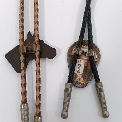 LOT 195: Tony Lama Tooled Leather Acorn Belt, Braided and Tooled Leather Belt Made in Mexico & (2) Vintage Bolo Ties