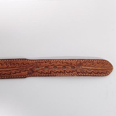 LOT 195: Tony Lama Tooled Leather Acorn Belt, Braided and Tooled Leather Belt Made in Mexico & (2) Vintage Bolo Ties