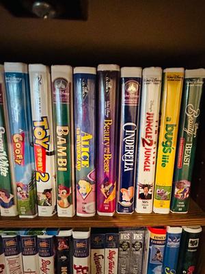 SEVERAL DISNEY MOVIES AND OTHER GREAT FAMILY MOVIES IN A NICE STORAGE CABINET