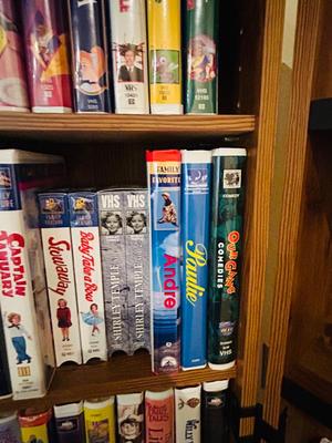 SEVERAL DISNEY MOVIES AND OTHER GREAT FAMILY MOVIES IN A NICE STORAGE CABINET