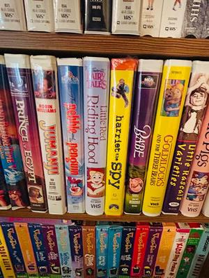SEVERAL DISNEY MOVIES AND OTHER GREAT FAMILY MOVIES IN A NICE STORAGE CABINET