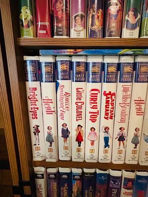 SEVERAL DISNEY MOVIES AND OTHER GREAT FAMILY MOVIES IN A NICE STORAGE CABINET