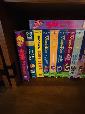 SEVERAL DISNEY MOVIES AND OTHER GREAT FAMILY MOVIES IN A NICE STORAGE CABINET