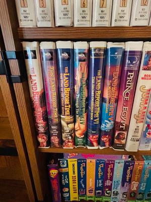 SEVERAL DISNEY MOVIES AND OTHER GREAT FAMILY MOVIES IN A NICE STORAGE CABINET