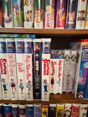 SEVERAL DISNEY MOVIES AND OTHER GREAT FAMILY MOVIES IN A NICE STORAGE CABINET