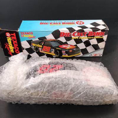 LOT 24: Miniature Hess Trucks, Texaco Havoline Racing Die-cast 1994 Bank, Mobil Collectible Toy Truck & More