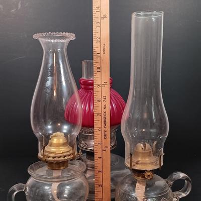 LOT 152: Oil Lamp with Unique Red and Clear Glass Shade & Set of (2) Finger Lamps