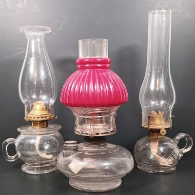 LOT 152: Oil Lamp with Unique Red and Clear Glass Shade & Set of (2) Finger Lamps