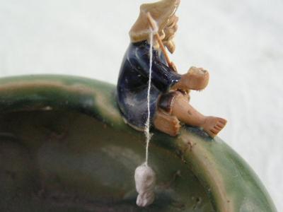 Small planter, ceramic, old man fishing & a frog on the rim.
