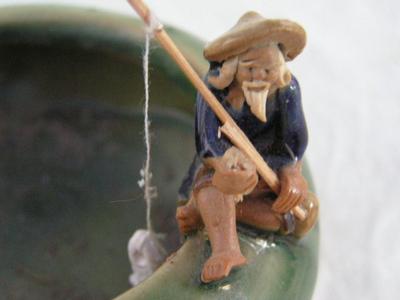 Small planter, ceramic, old man fishing & a frog on the rim.