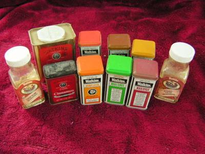 Group of Watkins spice tins and bottles.
