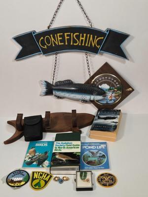 LOT 99L: Boy Scout Patches, Bird Books, Binoculars, Wooden Fish Shaped Rod Holder, Gone Fishing Sign, Sportsman Thermometer, Flyboys by...