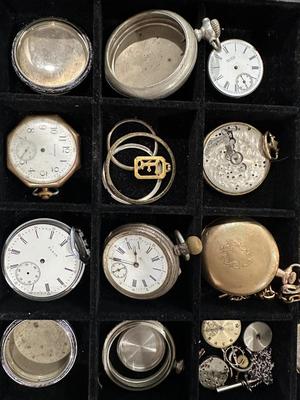 An assortment of Antique Watch parts and pieces from a Watchmakers bench for repairs and repurposing
