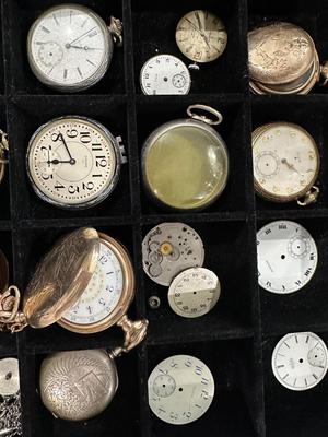 An assortment of Antique Watch parts and pieces from a Watchmakers bench for repairs and repurposing