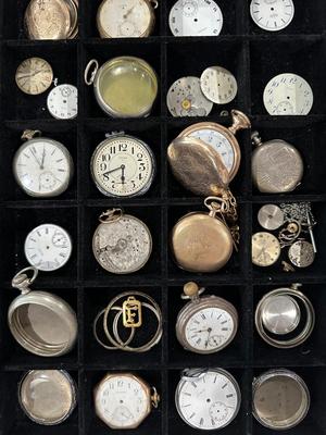 An assortment of Antique Watch parts and pieces from a Watchmakers bench for repairs and repurposing