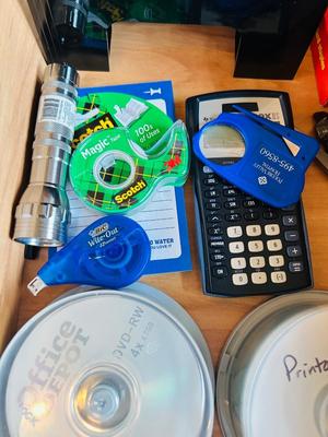 DESK DRAWER PACKED WITH DIFFERENT OFFICE SUPPLIES