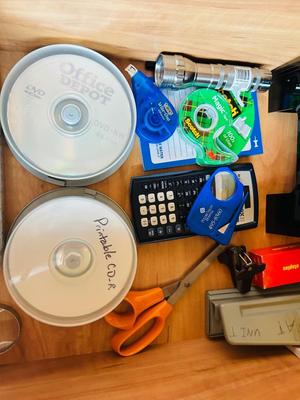 DESK DRAWER PACKED WITH DIFFERENT OFFICE SUPPLIES