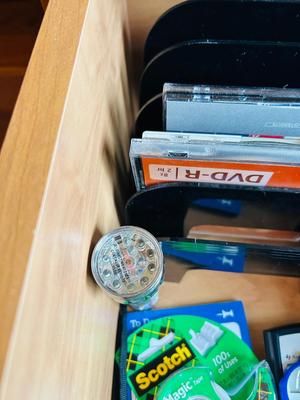 DESK DRAWER PACKED WITH DIFFERENT OFFICE SUPPLIES