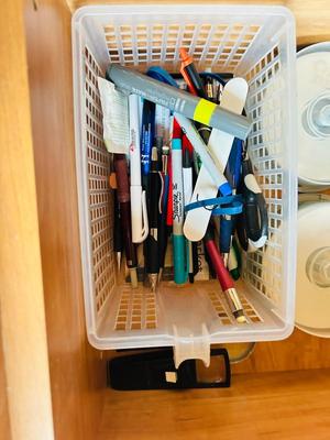 DESK DRAWER PACKED WITH DIFFERENT OFFICE SUPPLIES