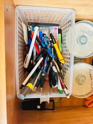 DESK DRAWER PACKED WITH DIFFERENT OFFICE SUPPLIES