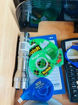 DESK DRAWER PACKED WITH DIFFERENT OFFICE SUPPLIES