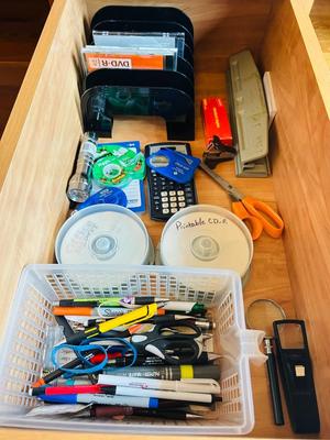 DESK DRAWER PACKED WITH DIFFERENT OFFICE SUPPLIES