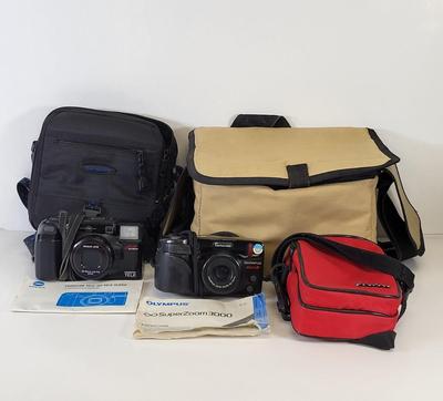 LOT 129: Pair of Olympus and Minolta Cameras With Travel Bags