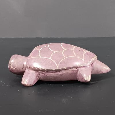LOT 121: Hand Carved Pearlite Stonecraft Duck, Hexagonal Metal Coin Bank, Carved Stone Game Token & More