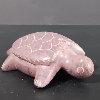 LOT 121: Hand Carved Pearlite Stonecraft Duck, Hexagonal Metal Coin Bank, Carved Stone Game Token & More