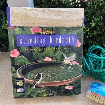 Sale Photo Thumbnail #1194: One Spiral Garden Hose, royal blue glazed bird bath, Chemical hose nossle, brush nossle, four wrought iron lawn decor
Bird Bath: 16" diameter