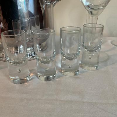 Sale Photo Thumbnail #1247: Decanter, 8 shot glasses, 2 small champagne glasses, 3 martini glasses, ice bucket with tongs (silver plated)
Ice bucket: 9" high x 7.5" wide
Decanter: 11" high