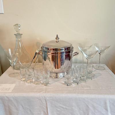 Sale Photo Thumbnail #1244: Decanter, 8 shot glasses, 2 small champagne glasses, 3 martini glasses, ice bucket with tongs (silver plated)
Ice bucket: 9" high x 7.5" wide
Decanter: 11" high