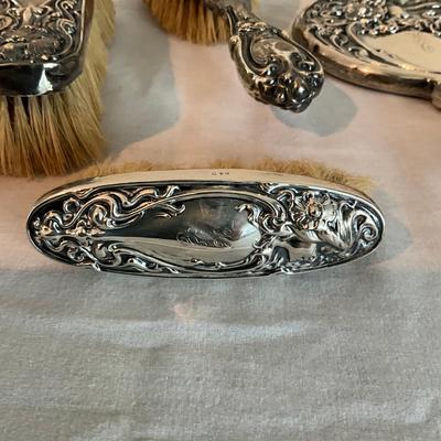 Sale Photo Thumbnail #1271: Three silver brushes in art nouveau style marked  925
Mirror is 9" long
Big brush is 8.5" long