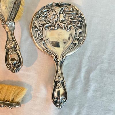 Sale Photo Thumbnail #1273: Three silver brushes in art nouveau style marked  925
Mirror is 9" long
Big brush is 8.5" long