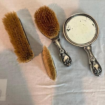 Sale Photo Thumbnail #1269: Three silver brushes in art nouveau style marked  925
Mirror is 9" long
Big brush is 8.5" long