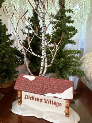 Dickens Village sign with collection of trees
